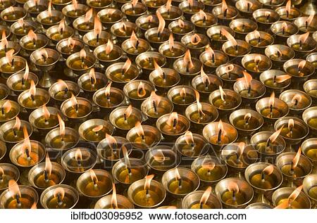 Stock Image - "Butterlamps, lighted, as offerings at Boudnath Stupa, Kathmandu Valley, Kathmandu, Kathmandu District, Bagmati Zone, Nepal, Asia". Fotosearch