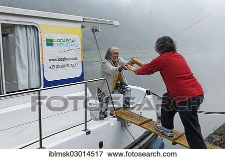 "Buying baguettes for breakfast, houseboat on the Canal des Vosges, formerly Canal de l'Est, in the port with morning mist, Fontenoy-le-Chateau, Epinal, Lorraine, Departement Vosges, France, Europe" View Large Photo Image Stock Photo - "Buying baguettes for breakfast, houseboat on the Canal des Vosges, formerly Canal de l'Est, in the port with morning mist, Fontenoy-le-Chateau, Epinal, Lorraine, Departement Vosges, France, Europe". Fotosearch