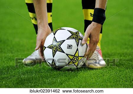 Stock Image - "BVB player taking the Champions League ball into his hands, UEFA Champions League, Borussia Dortmund - Ajax Amsterdam 1: 0, Signal Iduna Park, Dortmund, North Rhine-Westphalia, Germany, Europe". Fotosearch