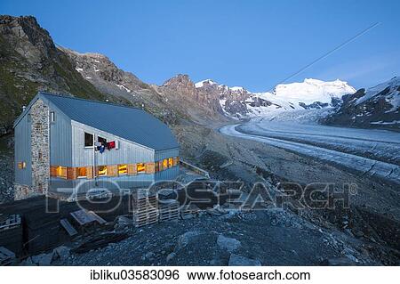 Stock Photograph - "Cabane de Pannossiere refuge, at back the Corbassiere Glacier and Mt Grand Combin, Val de Bagnes valley, Canton of Valais, Switzerland, Europe". Fotosearch