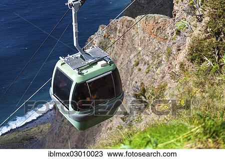 Stock Image - "Cable car on the cliff coast of Santa Maria Madalena, at the foot of Cabo Girao mountain near Achadas da Cruz, Porto Moinz, Santa Maria Madalena, Madeira, Portugal, Europe". Fotosearch