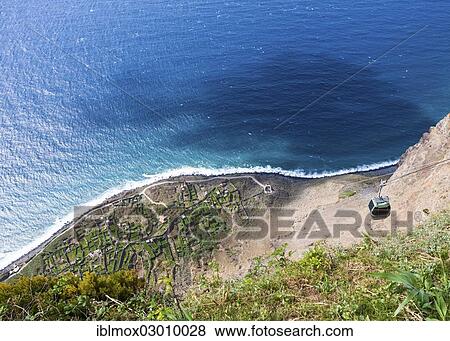 "Cable car on the cliff coast of Santa Maria Madalena, at the foot of Cabo Girao mountain near Achadas da Cruz, Porto Moinz, Santa Maria Madalena, Madeira, Portugal, Europe" View Large Photo Image Stock Photo - "Cable car on the cliff coast of Santa Maria Madalena, at the foot of Cabo Girao mountain near Achadas da Cruz, Porto Moinz, Santa Maria Madalena, Madeira, Portugal, Europe". Fotosearch