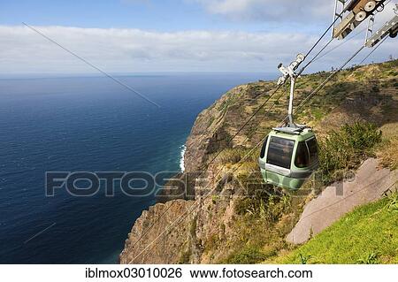 "Cable car on the cliff coast of Santa Maria Madalena, at the foot of Cabo Girao mountain near Achadas da Cruz, Porto Moinz, Santa Maria Madalena, Madeira, Portugal, Europe" View Large Photo Image Stock Photograph - "Cable car on the cliff coast of Santa Maria Madalena, at the foot of Cabo Girao mountain near Achadas da Cruz, Porto Moinz, Santa Maria Madalena, Madeira, Portugal, Europe". Fotosearch