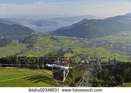 Stock Image - "CabriO Bahn, the world's first cable car with an open top deck, going up Stanserhorn Mountain, Stans, Switzerland, Europe". Fotosearch
