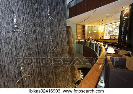 Cafe overlooking The Waterfall, an artificial indoor waterfall with life-size sculptures of divers, Dubai Mall, United Arab Emirates, Middle East, Asia View Large Photo Image Stock Image - Cafe overlooking The Waterfall, an artificial indoor waterfall with life-size sculptures of divers, Dubai Mall, United Arab Emirates, Middle East, Asia. Fotosearch
