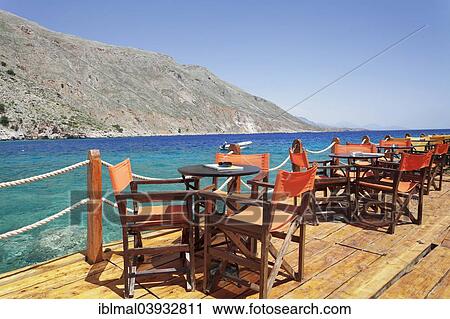 "Cafe terrace on the harbour promenade, Loutro, South Crete, Crete, Greece, Europe" View Large Photo Image Stock Image - "Cafe terrace on the harbour promenade, Loutro, South Crete, Crete, Greece, Europe". Fotosearch