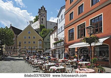 "Cafes in the pedestrian zone, Hohes Schloss, High Castle at back, Fuessen, Ostallgaeu, Allgaeu, Schwabia, Bavaria, Germany, Europe" View Large Photo Image Stock Photo - "Cafes in the pedestrian zone, Hohes Schloss, High Castle at back, Fuessen, Ostallgaeu, Allgaeu, Schwabia, Bavaria, Germany, Europe". Fotosearch