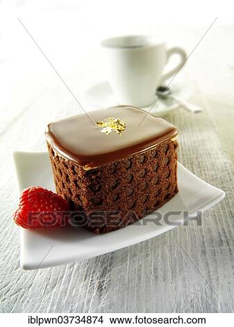 Cake with a sponge case and chocolate filling View Large Photo Image Picture - Cake with a sponge case and chocolate filling. Fotosearch