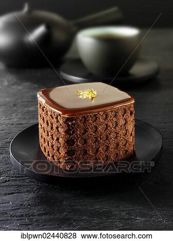 Cake with a sponge case and chocolate filling in a black Japanese tea setting View Large Photo Image Stock Photo - Cake with a sponge case and chocolate filling in a black Japanese tea setting. Fotosearch