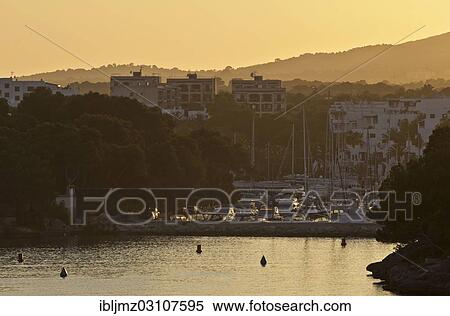 "Cala Llonga harbour at sunset, Cala d'Or, Mallorca, Majorca, Balearic Islands, Spain, Europe" View Large Photo Image Stock Photography - "Cala Llonga harbour at sunset, Cala d'Or, Mallorca, Majorca, Balearic Islands, Spain, Europe". Fotosearch