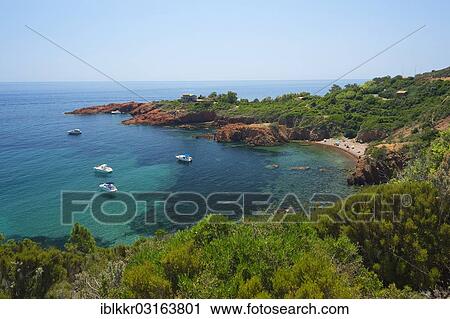 Stock Image - "Calanque bay with boats at Cap Roux in the Esterel mountains, Antheor, Saint-Raphael, French Riviera, Var, Provence-Alpes-Cote d? ÇÖAzur, France, Europe". Fotosearch