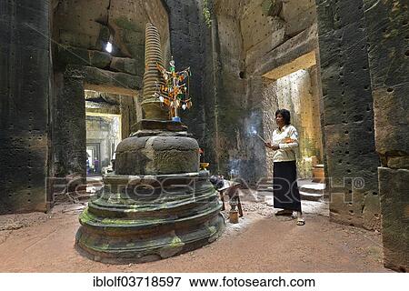 Stock Photo - "Cambodian with incense sticks in front of Stupa, Preah Khan, Angkor Wat, Siem Reap, Cambodia, Asia". Fotosearch