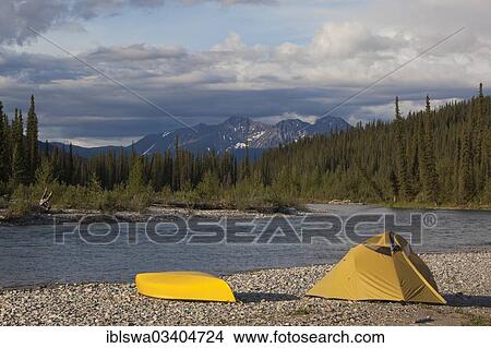 "camp on gravel bar, tent and canoe, Pelly Mountains behind, upper Liard River, Yukon Territory, Yukon Territory, Canada, North America" View Large Photo Image Picture - "camp on gravel bar, tent and canoe, Pelly Mountains behind, upper Liard River, Yukon Territory, Yukon Territory, Canada, North America". Fotosearch