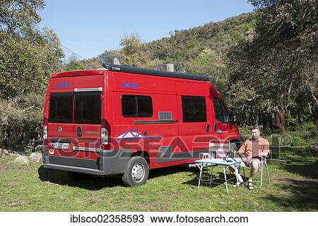 Stock Image - "Camping, campmobile, in a forest of cork oaks, Madonie mountains, Geraci Siculo, Sicily, Italy, Europe". Fotosearch