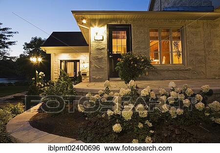 "Canadiana cottage style residential home exterior at dusk, Quebec, Canada, North America" View Large Photo Image Stock Photograph - "Canadiana cottage style residential home exterior at dusk, Quebec, Canada, North America". Fotosearch