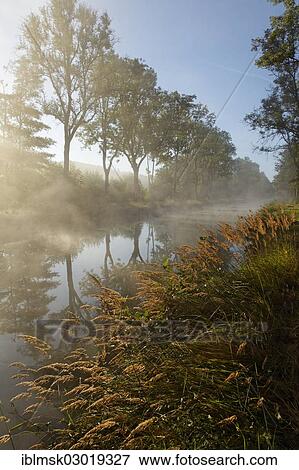 Stock Photo - "Canal des Vosges, formerly Canal de l'Est, at PK 100. 5, with morning fog and morning sun, Girancourt, Epinal, Lorraine, Departement Vosges, France, Europe". Fotosearch
