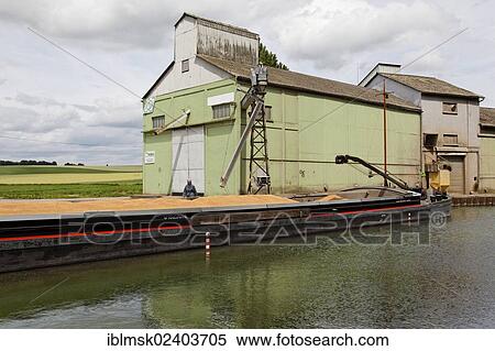 Stock Photography - "Canal of Saint-Quentin near Bellenglise, grain being loaded from a silo, Saint-Quentin, department of Aisne, Picardy region, France, Europe". Fotosearch