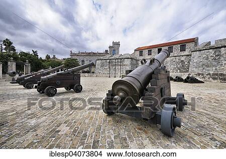 Picture - "Cannon at the Spanish fortress Castillo de la Real Fuerza, at the back the Palacio del Segundo Cabo, historic centre, La Habana Vieja, Havana, Ciudad de La Habana, Cuba, North America". Fotosearch
