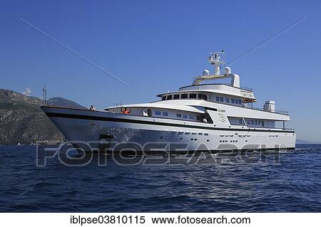 Stock Photography - "Cantieri Navali Nicolini motor yacht Il Cigno crosses at Cap Ferrat, Cote d'Azur, France, Mediterranean Sea, Europe". Fotosearch