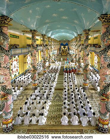 Stock Photograph - "Cao Dai Temple, interior during a mass with worshippers, Caodaiism, Tay Ninh, Sudvietnam, Vietnam, Asia". Fotosearch