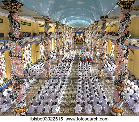 Stock Photography - "Cao Dai Temple, interior during a mass with worshippers, Caodaiism, Tay Ninh, Sudvietnam, Vietnam, Asia". Fotosearch
