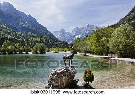 Stock Photo - "Capricorn sculpture on Lake Jasna in Triglav National Park, Julian Alps, near Kranjska Gora, Slovenia, Europe". Fotosearch