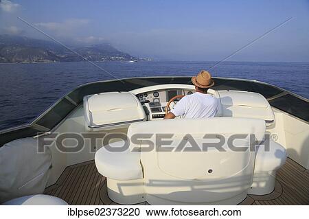 "Captain at the wheel on the flybridge, Leonardo II, a cruiser built by Azimut, type of boat: Leonardo 98, length: 30. 15 m, built in 2004, French Riviera, France, Mediterranean Sea, Europe" View Large Photo Image Stock Image - "Captain at the wheel on the flybridge, Leonardo II, a cruiser built by Azimut, type of boat: Leonardo 98, length: 30. 15 m, built in 2004, French Riviera, France, Mediterranean Sea, Europe". Fotosearch