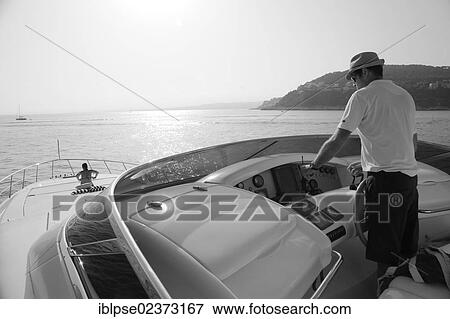 "Captain at the wheel on the flybridge, Leonardo II, a cruiser built by Azimut, type of boat: Leonardo 98, length: 30. 15 m, built in 2004, French Riviera, France, Mediterranean Sea, Europe" View Large Photo Image Stock Photo - "Captain at the wheel on the flybridge, Leonardo II, a cruiser built by Azimut, type of boat: Leonardo 98, length: 30. 15 m, built in 2004, French Riviera, France, Mediterranean Sea, Europe". Fotosearch
