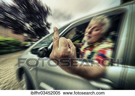 Stock Photography - "Car driver giving the finger, Grevenbroich, Rhineland, North Rhine-Westphalia, Germany, Europe". Fotosearch