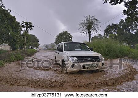 "Car driving on a flooded street during the rainy season, near Makeni, Bombali District, Sierra Leone, Africa" View Large Photo Image Stock Image - "Car driving on a flooded street during the rainy season, near Makeni, Bombali District, Sierra Leone, Africa". Fotosearch