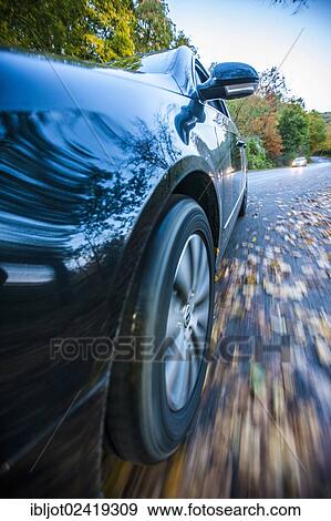 Car driving on a street covered with leaves, in autumn, dangerous driving conditions, danger of accident View Large Photo Image Stock Photo - Car driving on a street covered with leaves, in autumn, dangerous driving conditions, danger of accident. Fotosearch