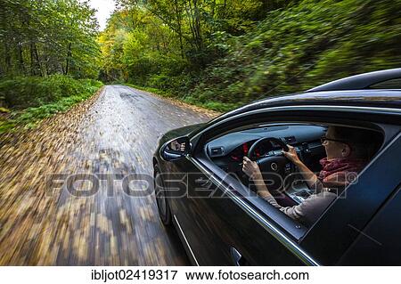 Car driving on a street covered with leaves, in autumn, dangerous driving conditions, danger of accident View Large Photo Image Stock Photo - Car driving on a street covered with leaves, in autumn, dangerous driving conditions, danger of accident. Fotosearch