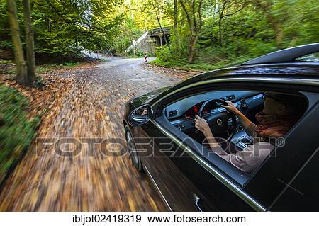 Car driving on a street covered with leaves, in autumn, dangerous driving conditions, danger of accident View Large Photo Image Stock Photo - Car driving on a street covered with leaves, in autumn, dangerous driving conditions, danger of accident. Fotosearch