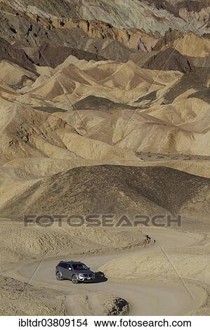 "Car driving on the road through the badlands of the """"Twenty Mule Team Canyon"""" in the morning light, Death Valley, Death Valley National Park, California, USA" View Large Photo Image Picture - "Car driving on the road through the badlands of the """"Twenty Mule Team Canyon"""" in the morning light, Death Valley, Death Valley National Park, California, USA". Fotosearch