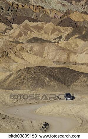 "Car driving on the road through the badlands of the """"Twenty Mule Team Canyon"""" in the morning light, Death Valley, Death Valley National Park, California, USA" View Large Photo Image Stock Image - "Car driving on the road through the badlands of the """"Twenty Mule Team Canyon"""" in the morning light, Death Valley, Death Valley National Park, California, USA". Fotosearch