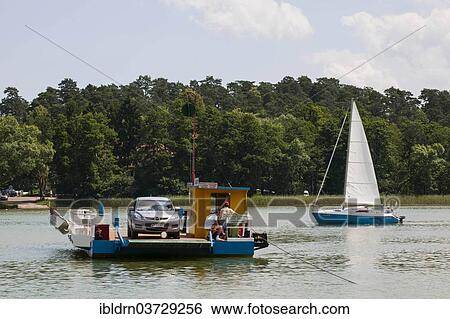 Stock Photograph - "Car ferry crossing Lake Beldany, Masurian Lake District or Masurian Lakeland, Mikolajki, Warmian-Masurian Voivodeship, Poland, Europe". Fotosearch