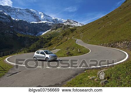 "Car in a hairpin curve, mountain road to the Klausen Pass in front of the Glarus Alps, Urnerboden, Canton of Uri, Switzerland, Europe" View Large Photo Image Stock Photo - "Car in a hairpin curve, mountain road to the Klausen Pass in front of the Glarus Alps, Urnerboden, Canton of Uri, Switzerland, Europe". Fotosearch