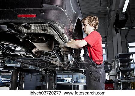 "Car mechanic changing tyres in a car repair shop, St. Gertraudi, Reith im Alpbachtal, Kufstein District, North Tirol, Tirol, Austria, Europe" View Large Photo Image Stock Photo - "Car mechanic changing tyres in a car repair shop, St. Gertraudi, Reith im Alpbachtal, Kufstein District, North Tirol, Tirol, Austria, Europe". Fotosearch