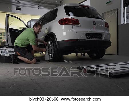 "Car mechanic taking axis measurements with a laser, VW Strasser, Volkswagen car repair shop, St. Gertraudi, Reith im Alpbachtal, Kufstein District, North Tirol, Tirol, Austria, Europe" View Large Photo Image Stock Photo - "Car mechanic taking axis measurements with a laser, VW Strasser, Volkswagen car repair shop, St. Gertraudi, Reith im Alpbachtal, Kufstein District, North Tirol, Tirol, Austria, Europe". Fotosearch