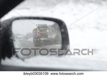 "Car mirror reflecting a snow-clearing vehicle from the motorway maintenance authorities in operation on the A8 motorway, Wendlingen, Baden-Wurttemberg, Germany, Europe" View Large Photo Image Stock Photo - "Car mirror reflecting a snow-clearing vehicle from the motorway maintenance authorities in operation on the A8 motorway, Wendlingen, Baden-Wurttemberg, Germany, Europe". Fotosearch