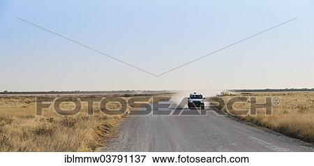 Stock Photo - "Car travelling on a dirt road, Etosha National Park, Namibia, Africa". Fotosearch