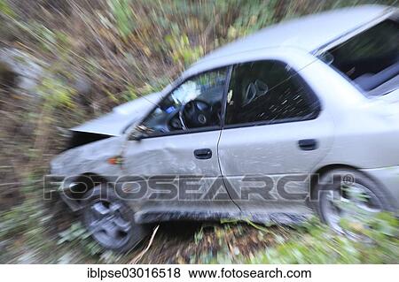 Stock Photo - "Car which has driven off the road and down an embankment, traffic accident". Fotosearch