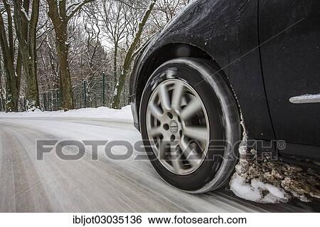 Car with winter tyres driving on a road covered with snow View Large Photo Image Stock Photograph - Car with winter tyres driving on a road covered with snow. Fotosearch