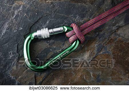 Carabiner with rope on a stone surface View Large Photo Image Stock Photography - Carabiner with rope on a stone surface. Fotosearch