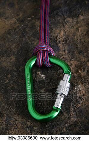 Carabiner with safety rope on a stone surface View Large Photo Image Stock Image - Carabiner with safety rope on a stone surface. Fotosearch