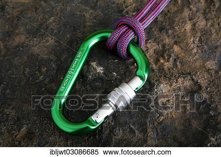 Carabiner with safety rope on a stone surface View Large Photo Image Stock Photography - Carabiner with safety rope on a stone surface. Fotosearch