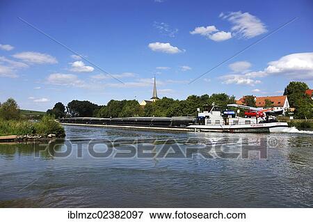 "Cargo ship on the Main river, behind the steeple of Fahr, Wipfeld, Lower Franconia, Bavaria, Germany, Europe" View Large Photo Image Stock Photo - "Cargo ship on the Main river, behind the steeple of Fahr, Wipfeld, Lower Franconia, Bavaria, Germany, Europe". Fotosearch