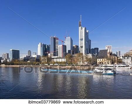 "Cargo ship on the Main river in front of the skyline of Frankfurt with the buildings of Opernturm, Frankfurt Cathedral, Deutsche Bank, Hessische Landesbank, Commerzbank, TaunusTurm, ECB, Frankfurt am Main, Hesse, Germany, Europe" View Large Photo Image Stock Photo - "Cargo ship on the Main river in front of the skyline of Frankfurt with the buildings of Opernturm, Frankfurt Cathedral, Deutsche Bank, Hessische Landesbank, Commerzbank, TaunusTurm, ECB, Frankfurt am Main, Hesse, Germany, Europe". Fotosearch