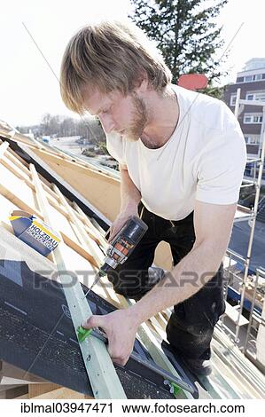 Carpenter at work on a roof truss View Large Photo Image Stock Image - Carpenter at work on a roof truss. Fotosearch