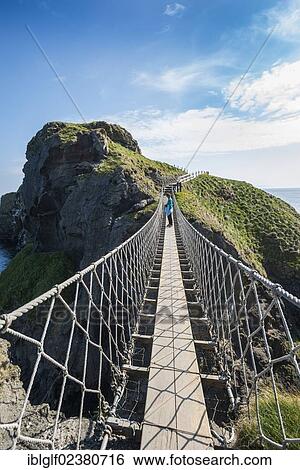"Carrick-a-Rede Bridge, woman standing on the suspension bridge, Moyle, Northern Ireland, United Kingdom, Europe" View Large Photo Image Stock Photograph - "Carrick-a-Rede Bridge, woman standing on the suspension bridge, Moyle, Northern Ireland, United Kingdom, Europe". Fotosearch